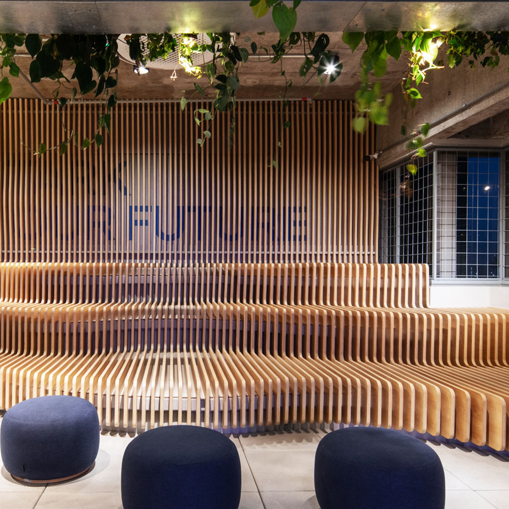 Wooden slatted seating with the tagline Stark your future in the background, among plants