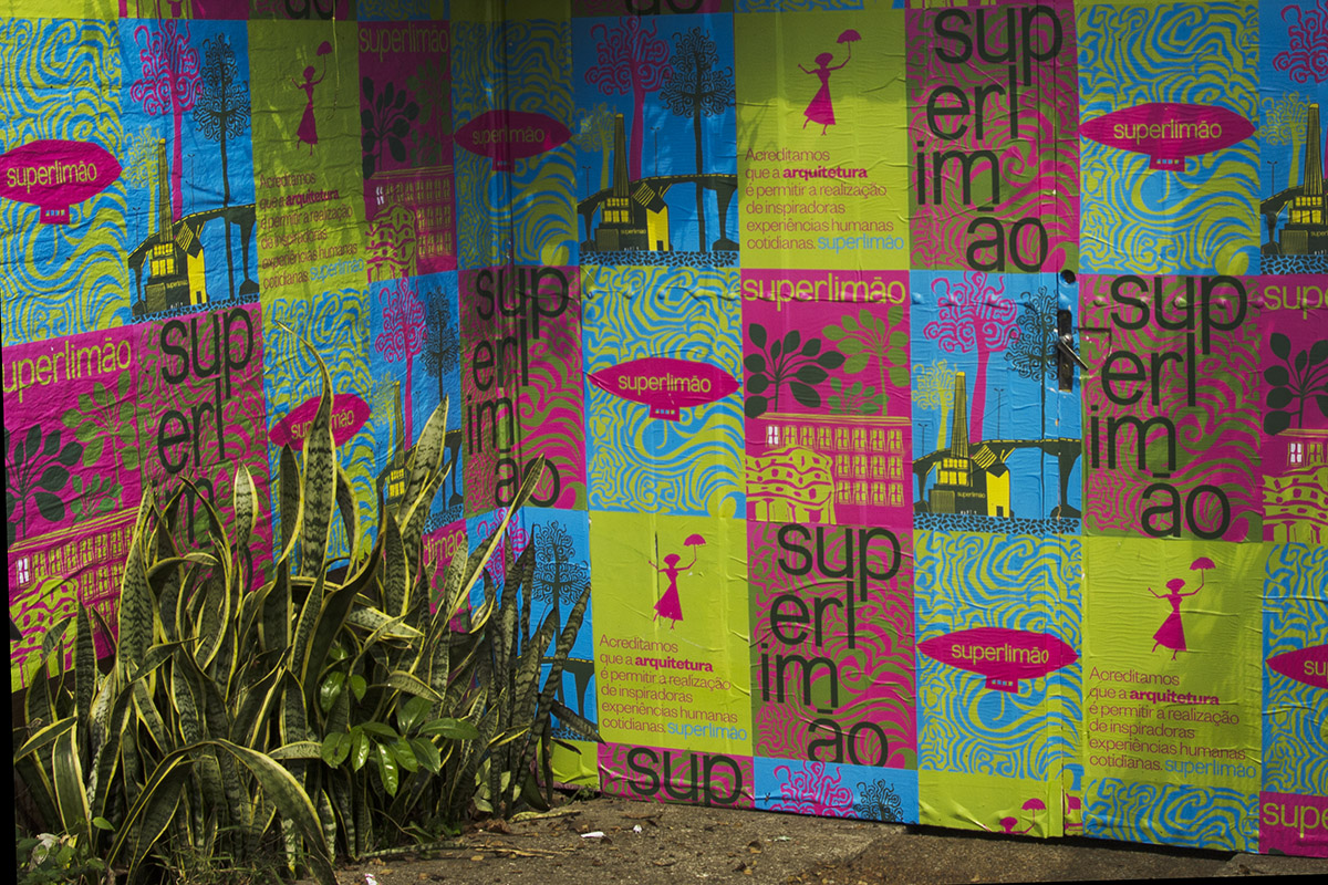 Wall covered in colourful paste-ups bearing the Superlimão brand