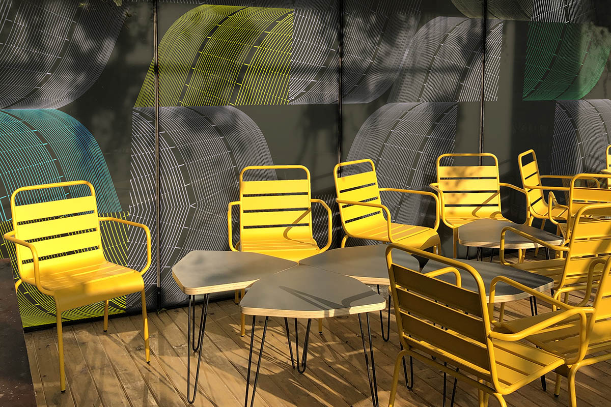 U!mano balcony with yellow chairs and a patterned wall
